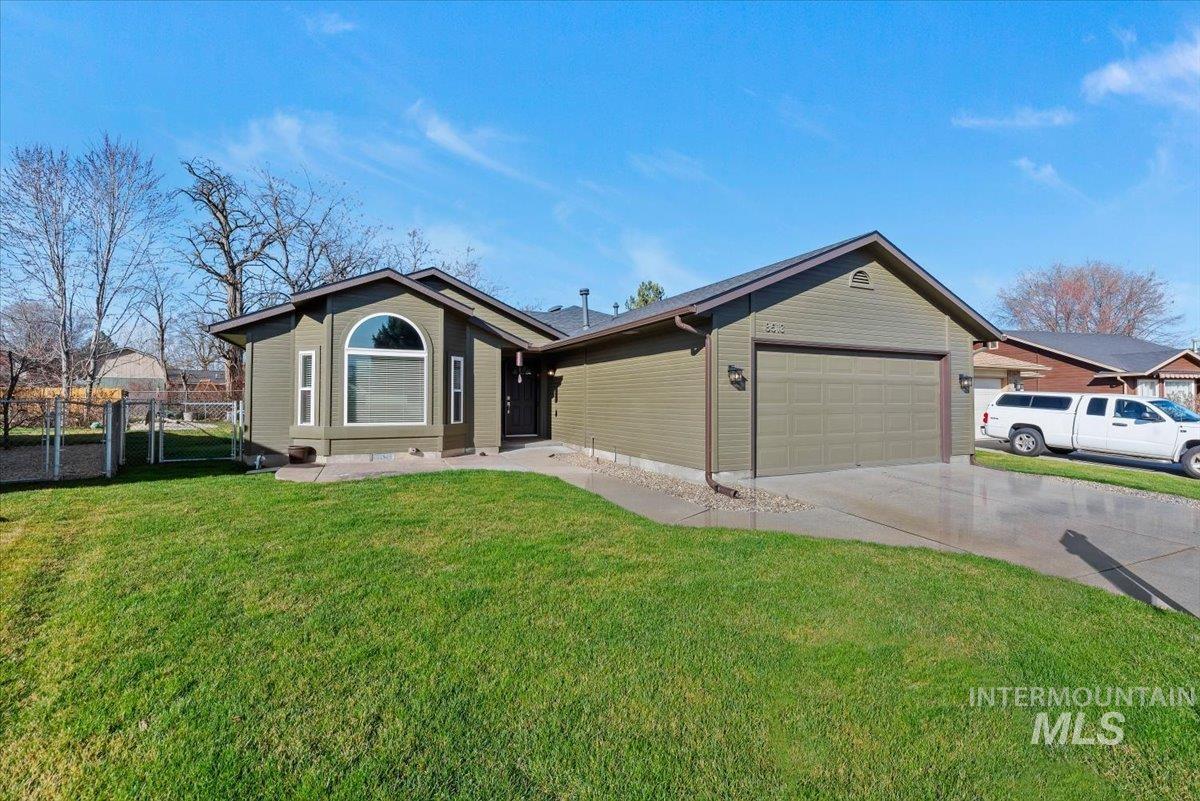 Ranch-style home with a gate, a garage, and concrete driveway