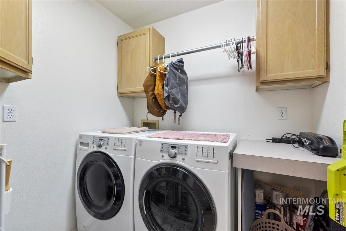 Laundry room with cabinet space and washing machine and clothes dryer