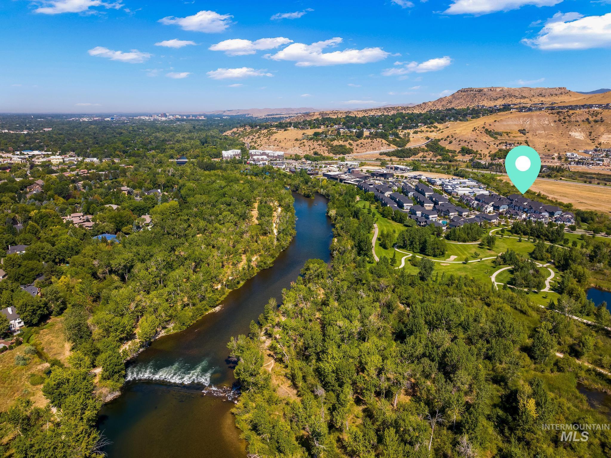 Aerial view of property and surrounding area with a water and mountain view