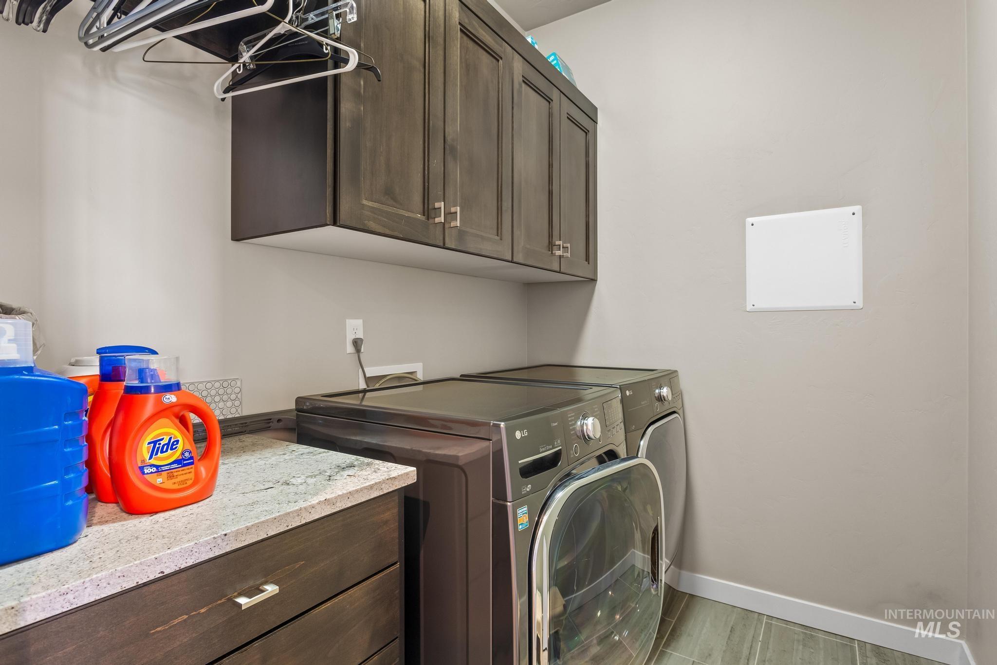Laundry area with cabinet space and independent washer and dryer