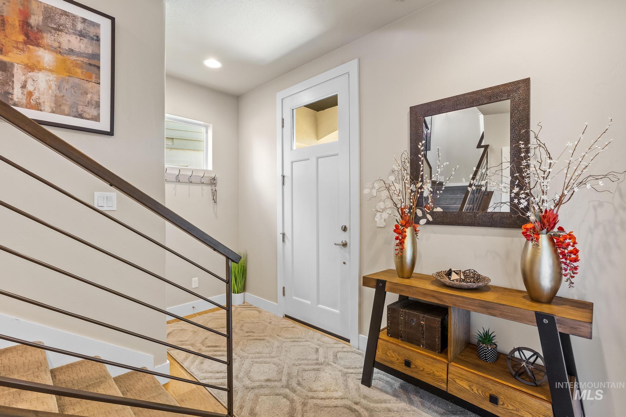Foyer entrance featuring stairs, carpet flooring, and recessed lighting