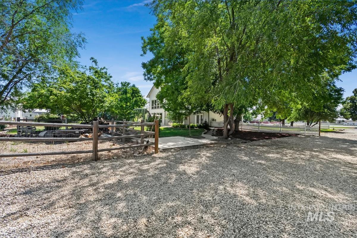 Gravel driveway with established trees providing natural shading