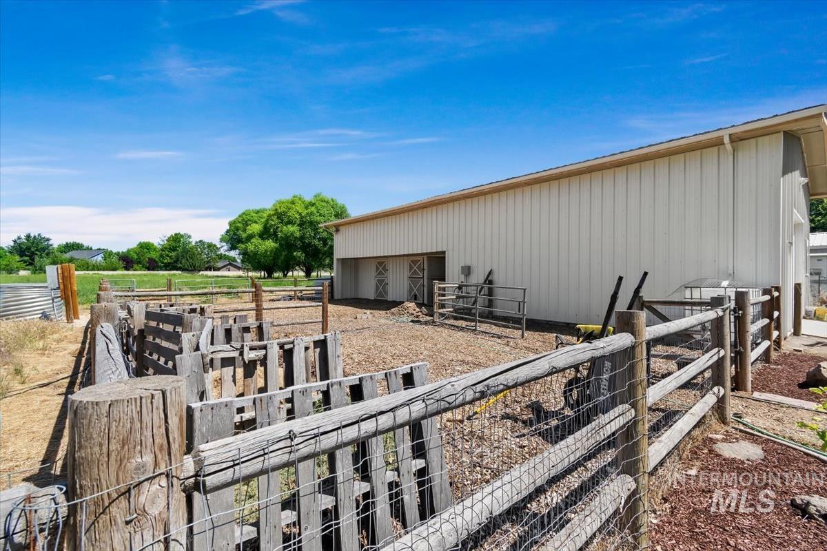 White metal-sided barn with two accessible bay entries