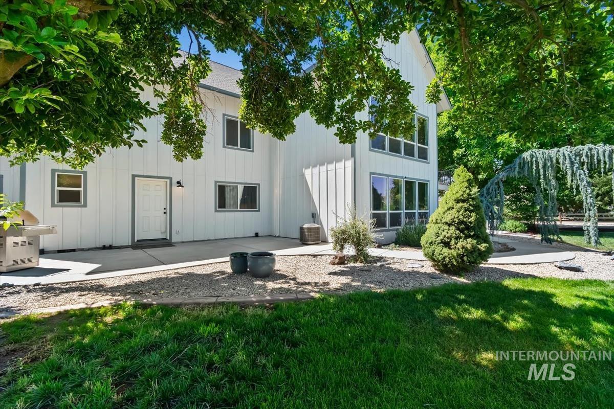 White vertical siding exterior with contrasting trim, featuring multiple windows