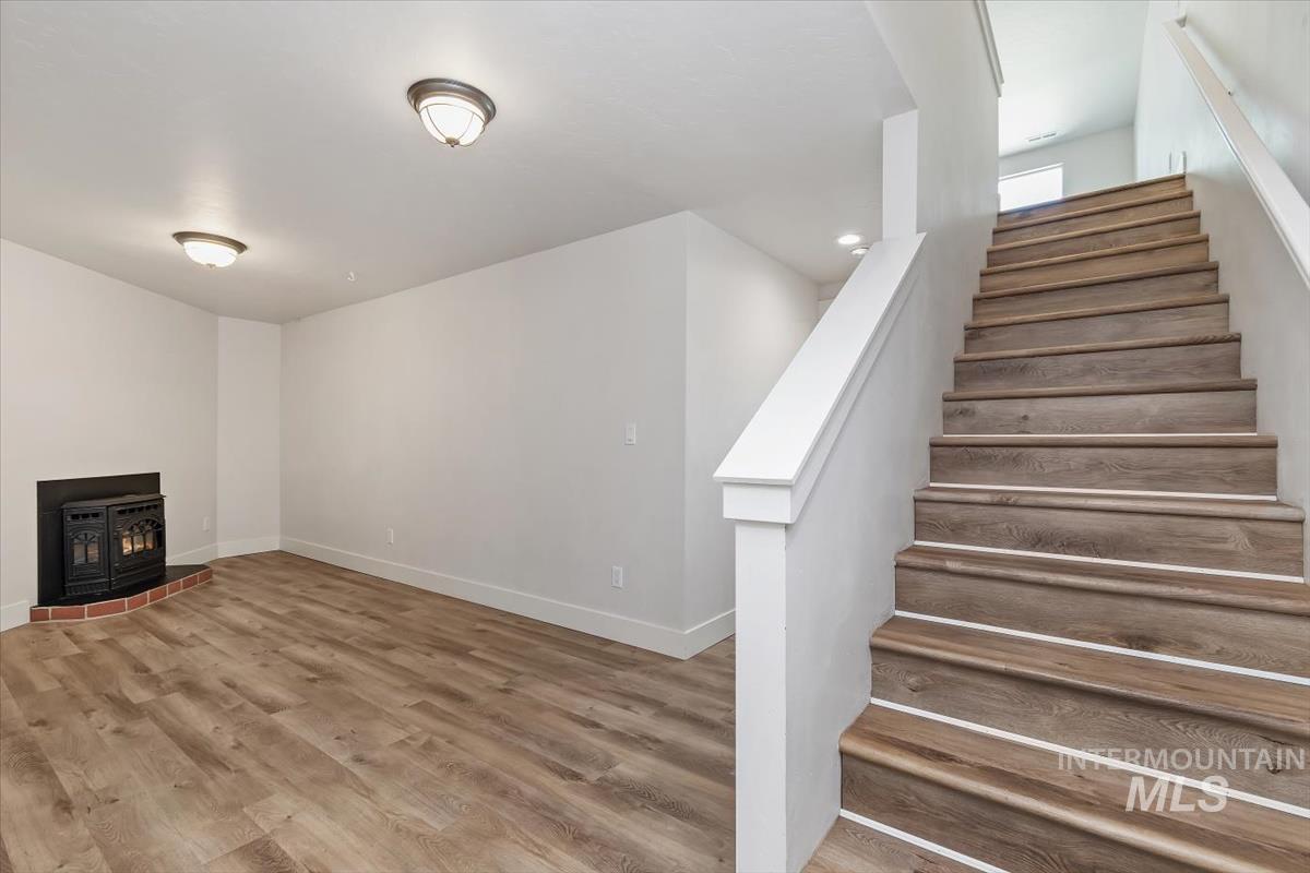 Staircase with wood-finish treads and white risers, featuring a white handrail