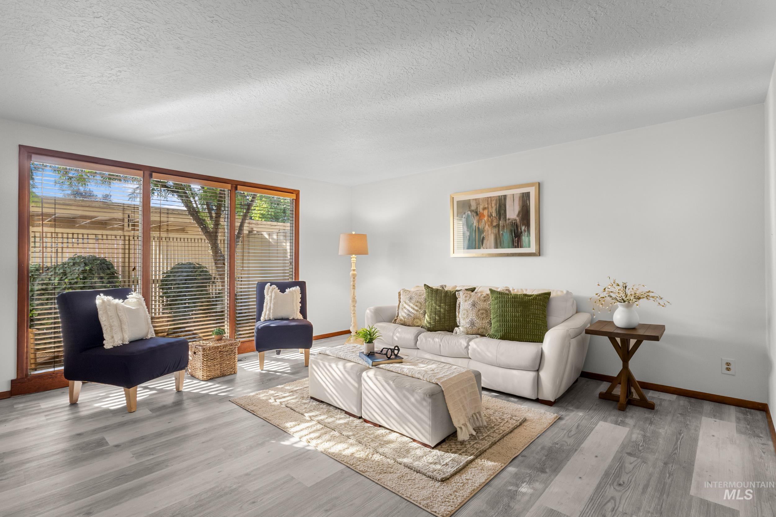 Living room featuring a textured ceiling and wood finished floors
