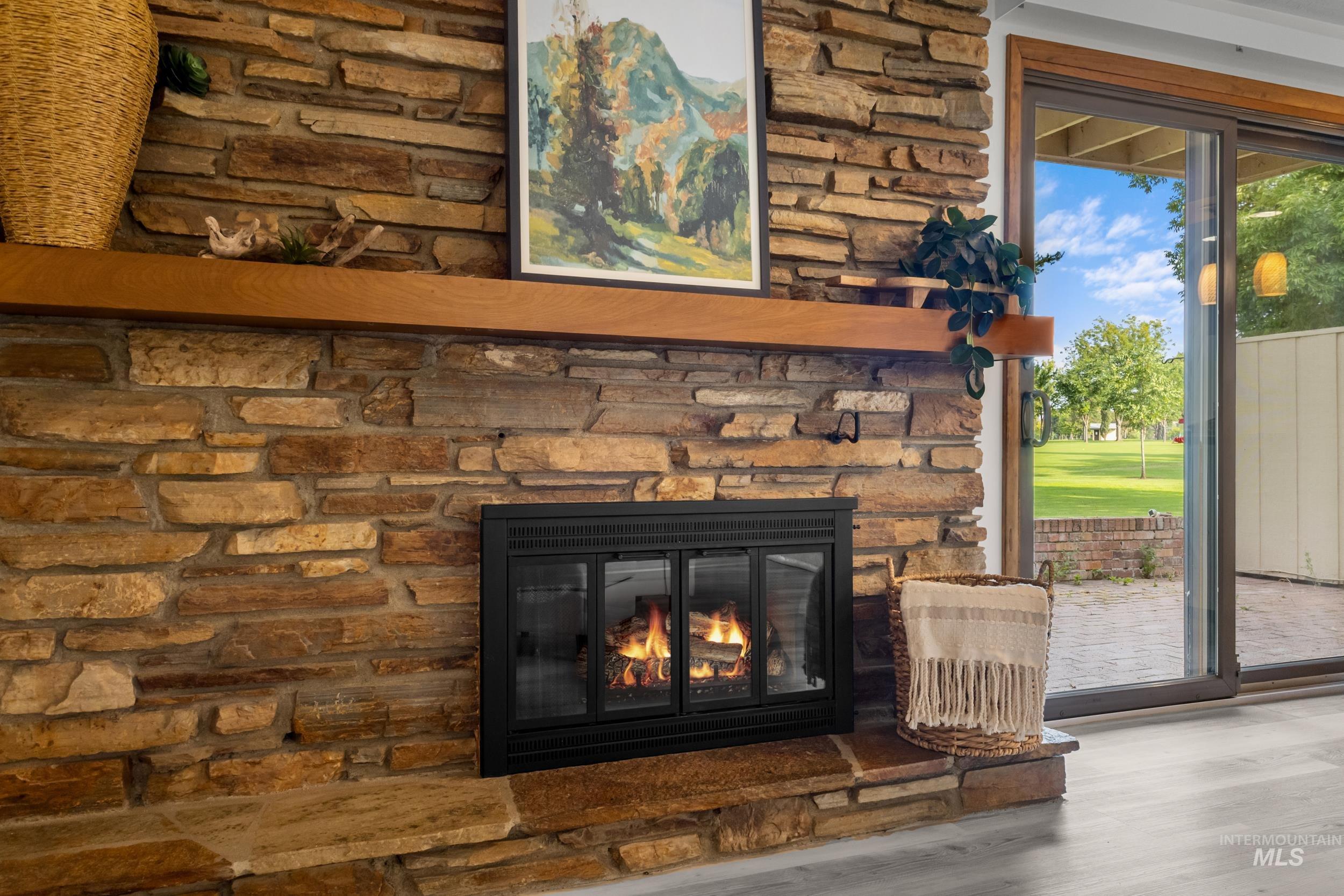 Detailed view of a fireplace and wood finished floors
