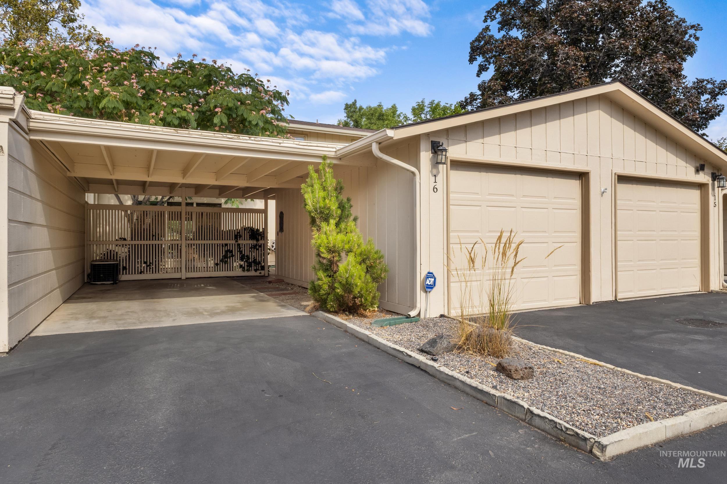 View of front of house with a garage and asphalt driveway