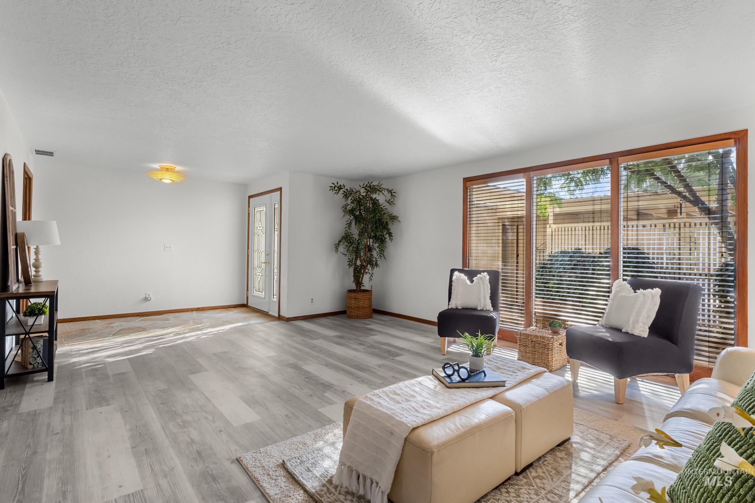 Living room featuring a textured ceiling and light wood finished floors
