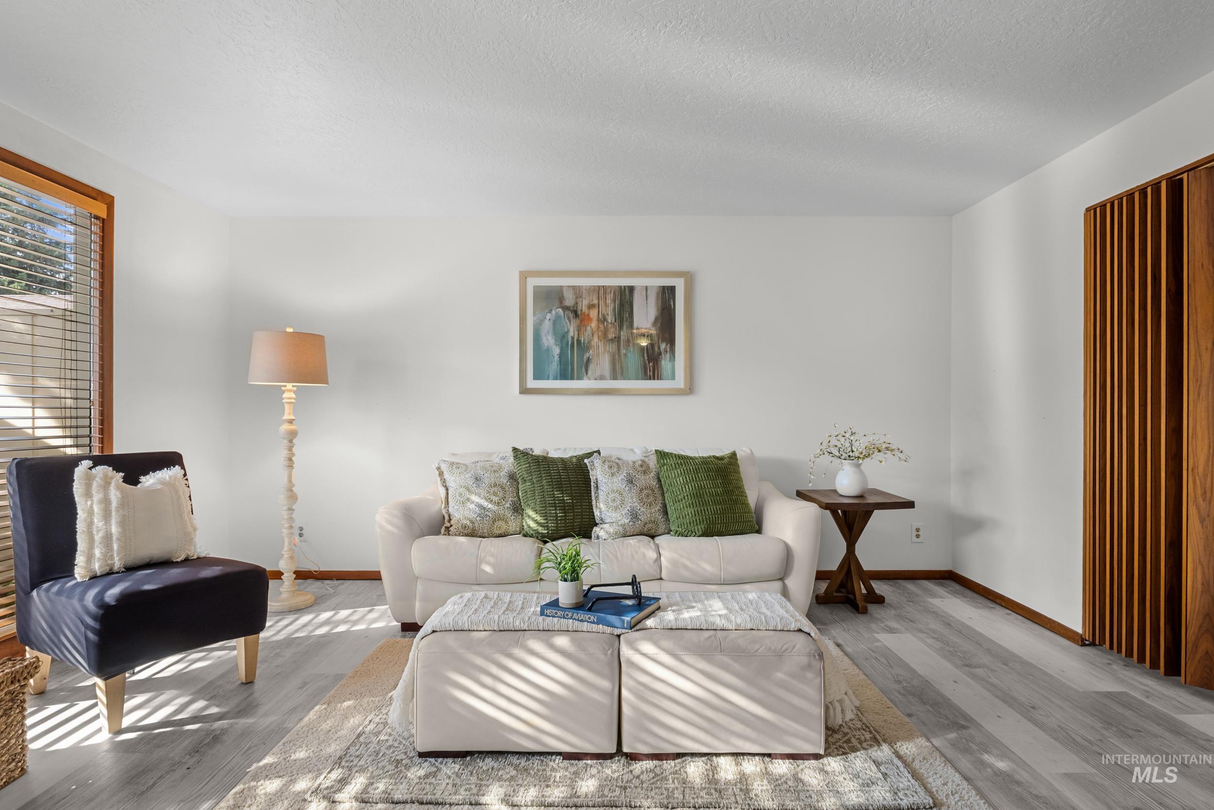 Living room with wood finished floors and a textured ceiling