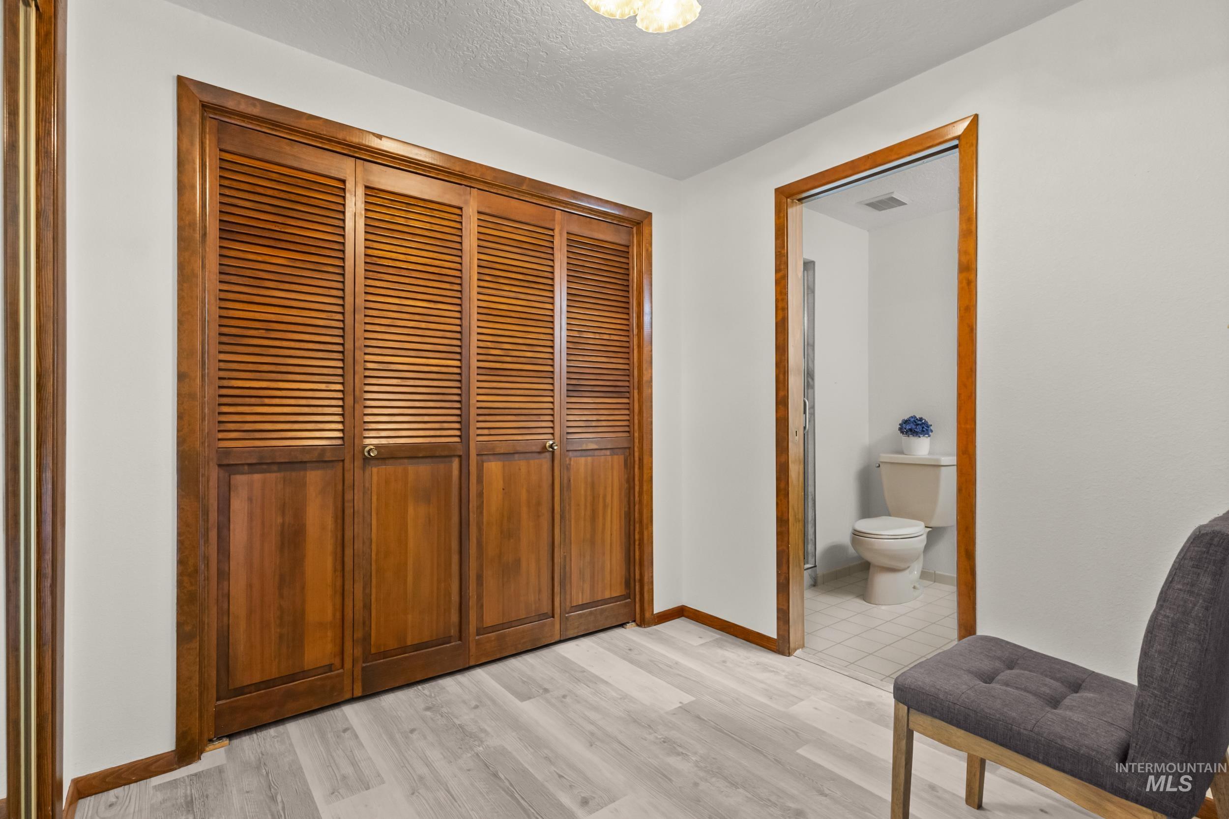 Hall with light wood finished floors and a textured ceiling