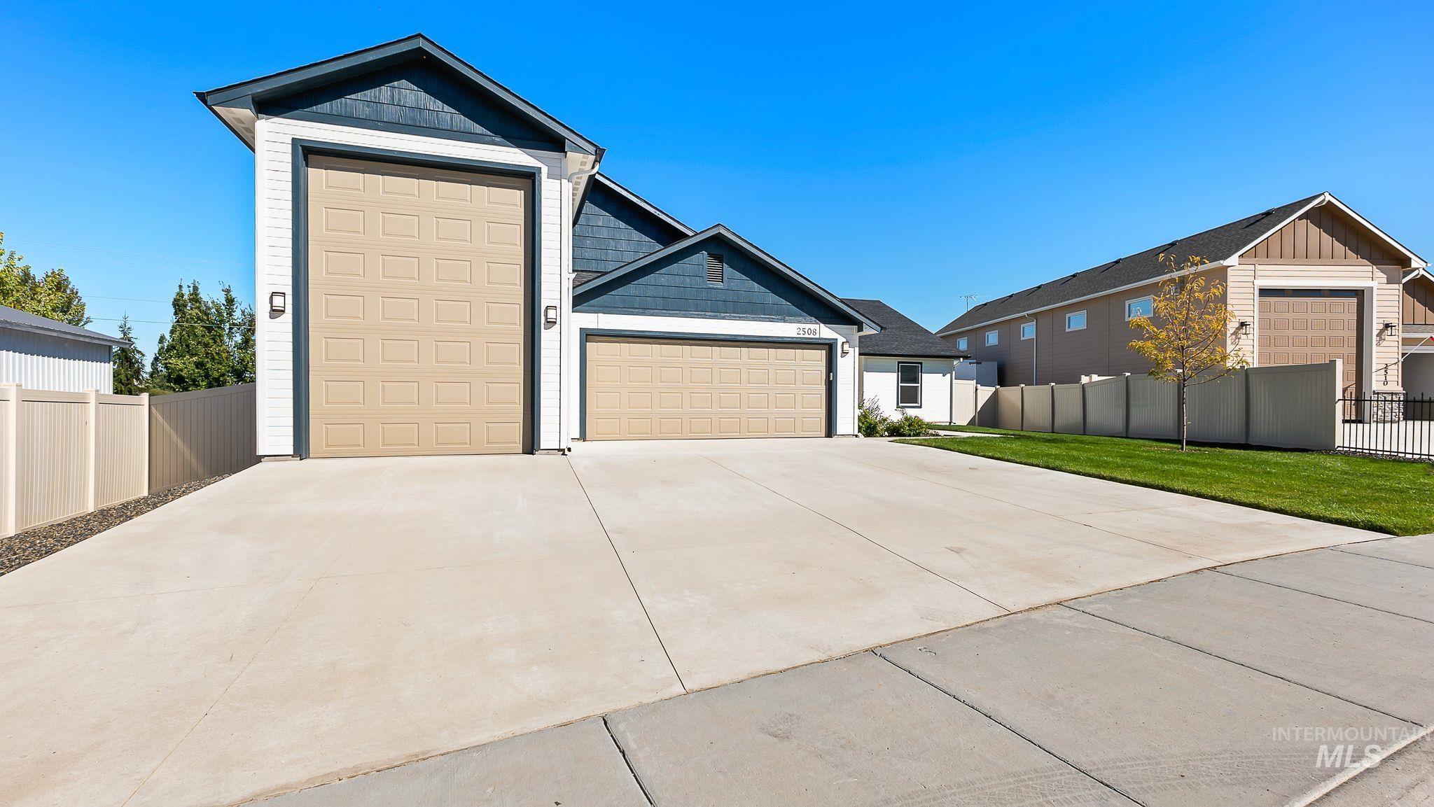 View of front of property with driveway, board and batten siding, and a garage