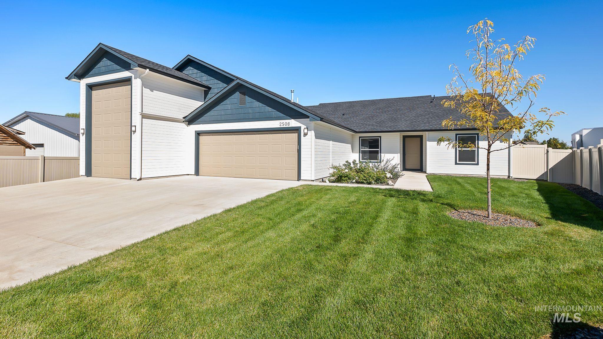 Ranch-style home with an attached garage, concrete driveway, and a shingled roof