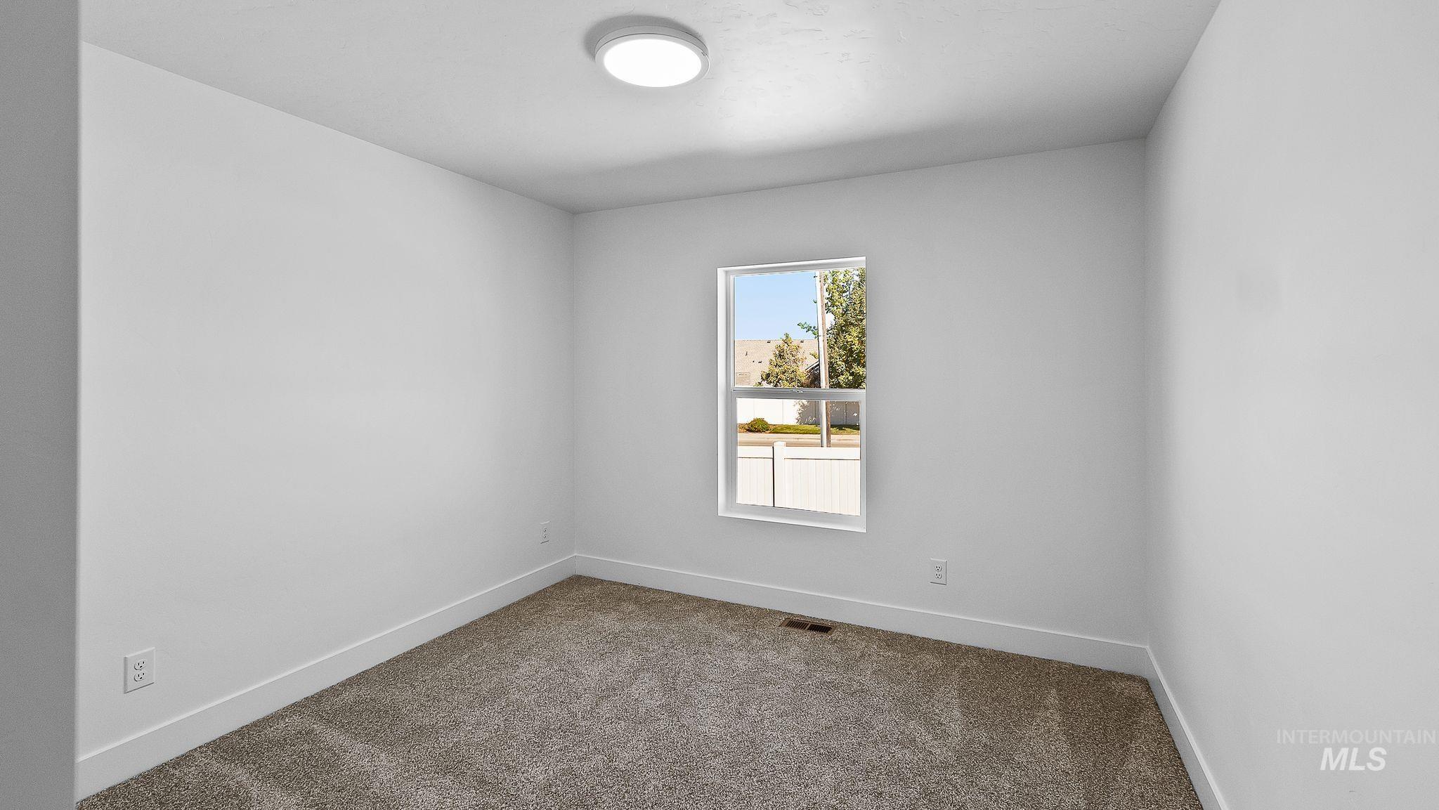 Spare room with carpet flooring and baseboards