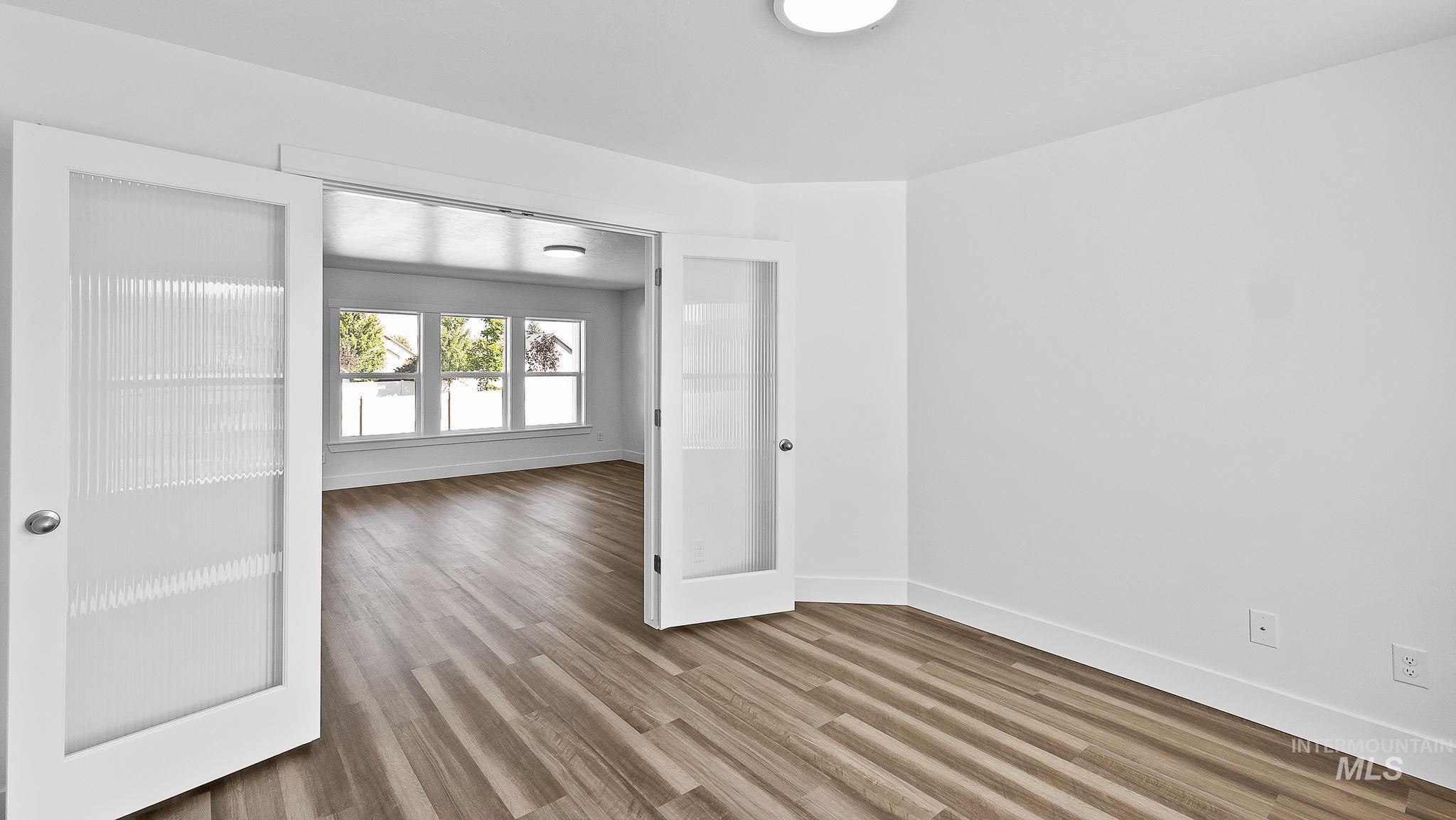 Spare room with light wood-style floors and baseboards