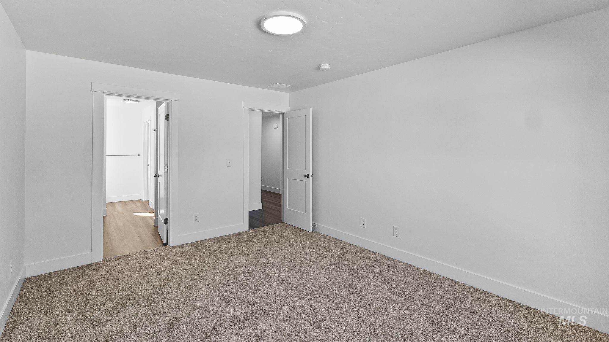 Unfurnished bedroom featuring carpet and baseboards