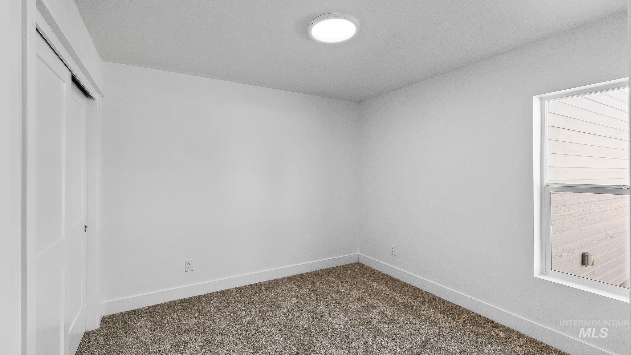 Unfurnished bedroom featuring carpet and a closet