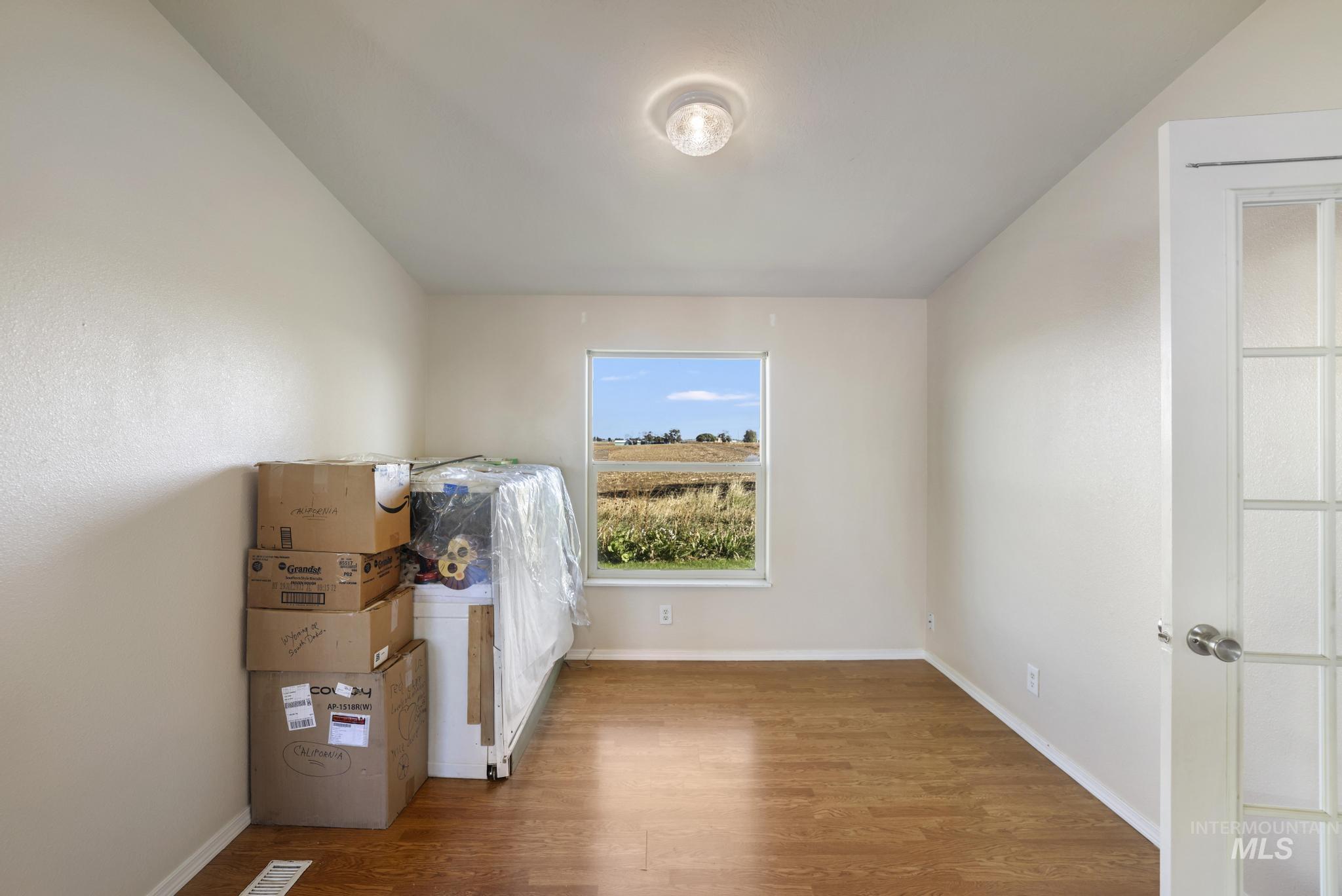 Additional living space with wood finished floors and baseboards
