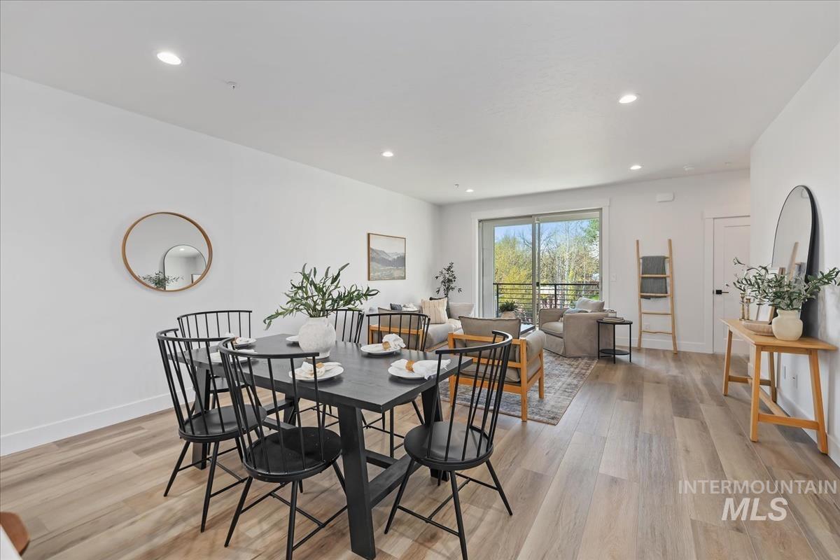 Dining area with light wood-type flooring and recessed lighting
