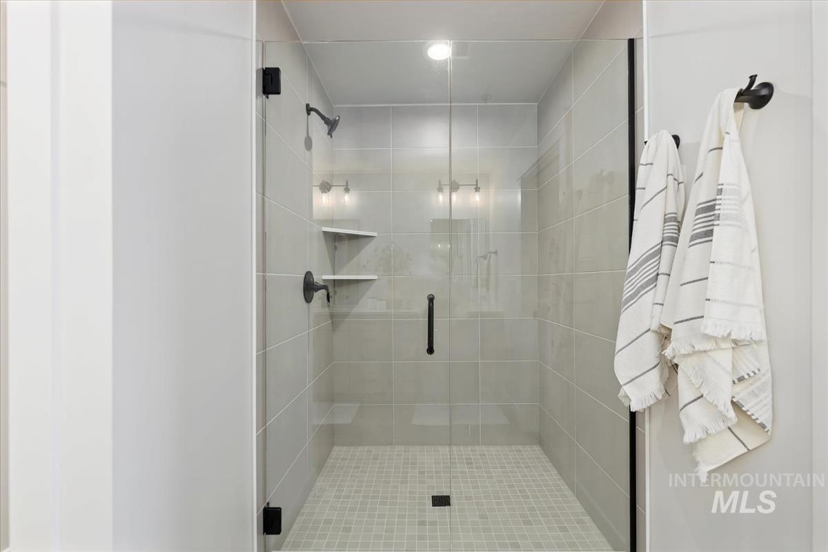 Full bathroom with a shower stall