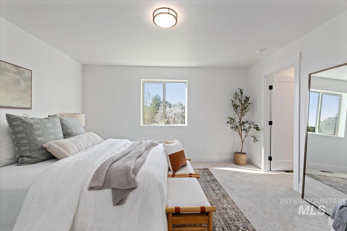 Carpeted bedroom featuring baseboards