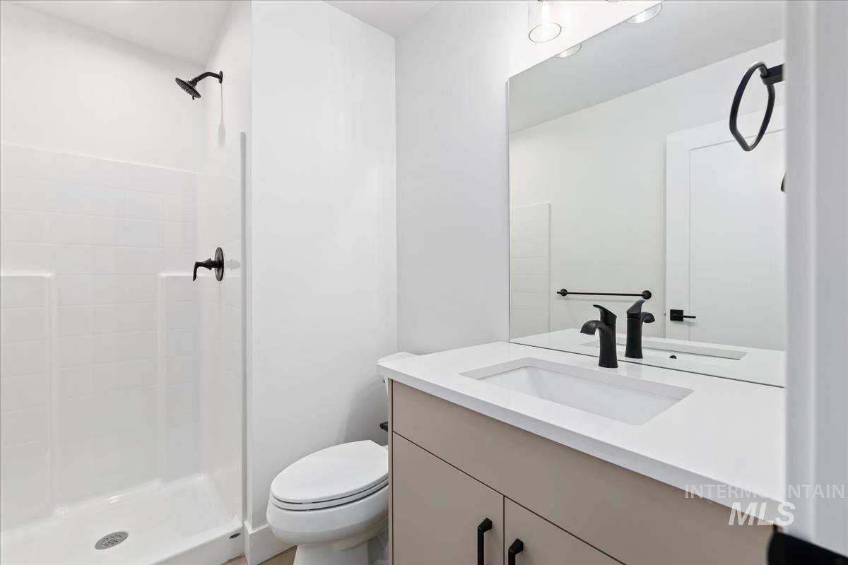 Bathroom featuring vanity and a shower