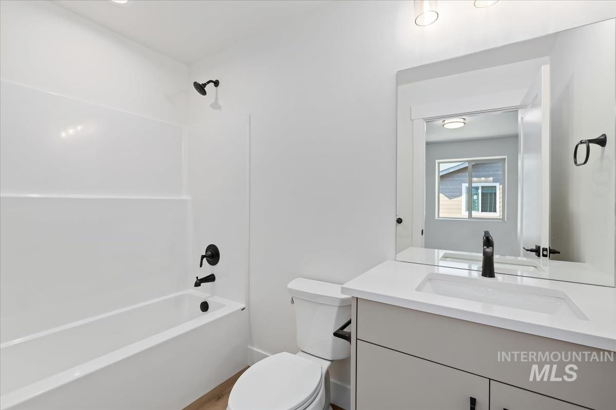 Bathroom featuring vanity and shower / washtub combination