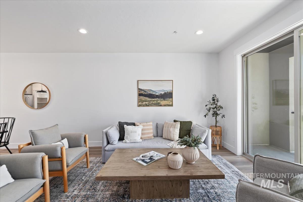 Living area featuring wood finished floors and recessed lighting