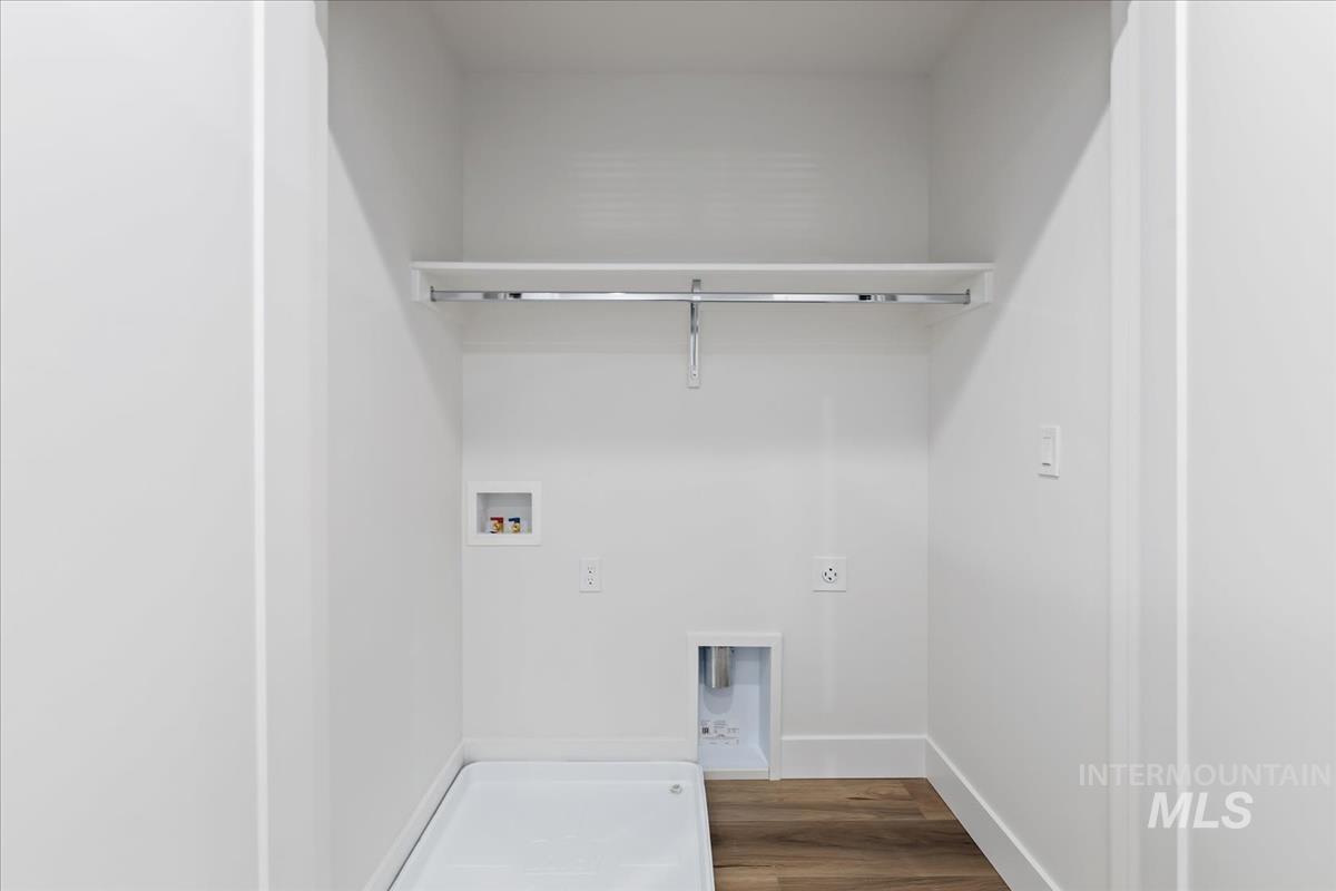 Laundry room featuring hookup for a washing machine, hookup for an electric dryer, and wood finished floors