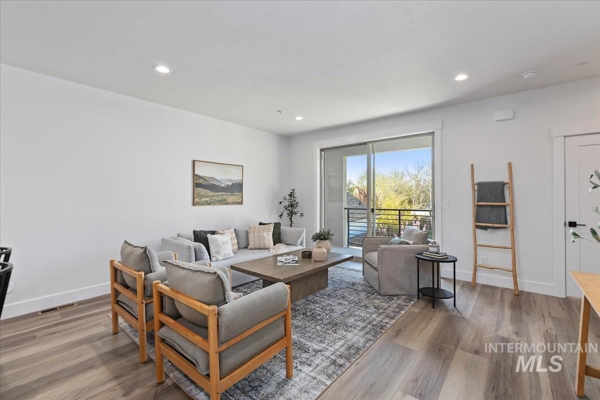 Living area featuring wood finished floors and recessed lighting