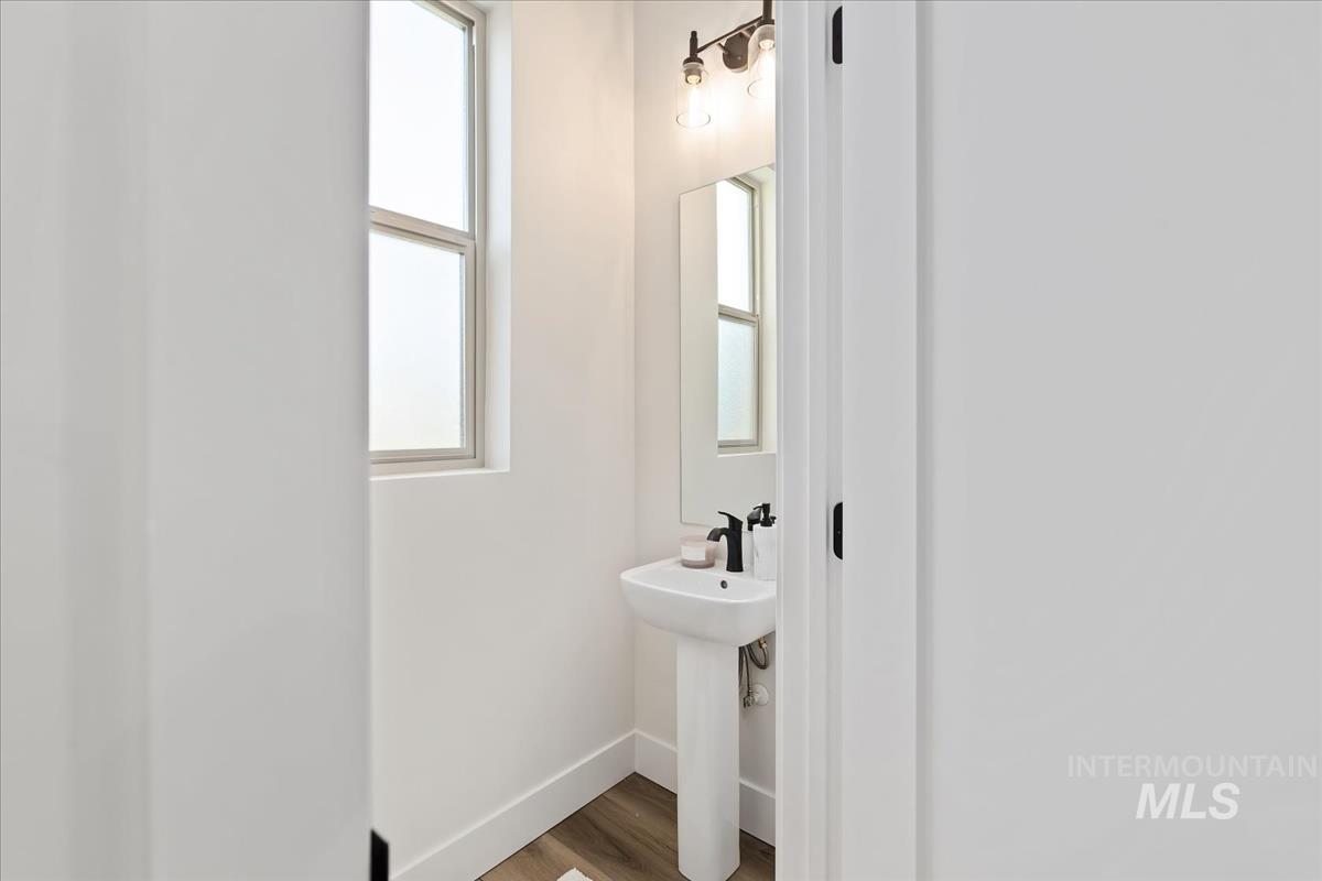 Bathroom featuring baseboards and wood finished floors