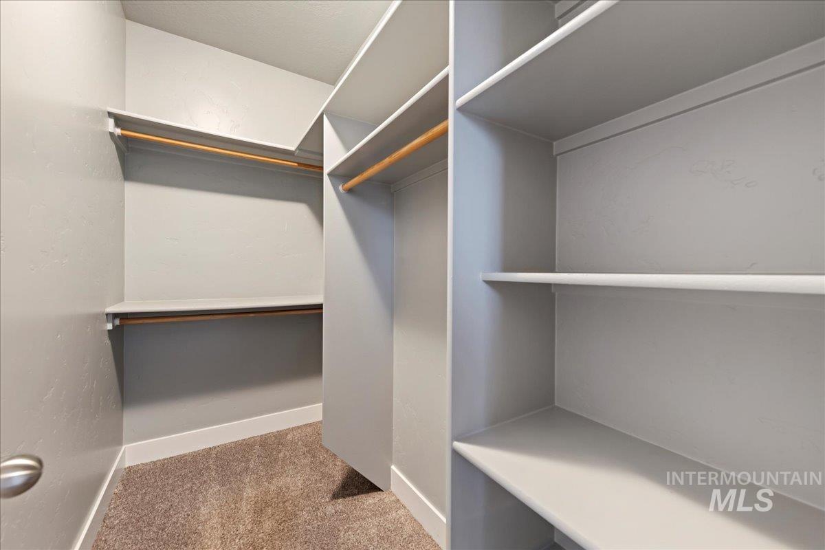 Spacious closet with light carpet