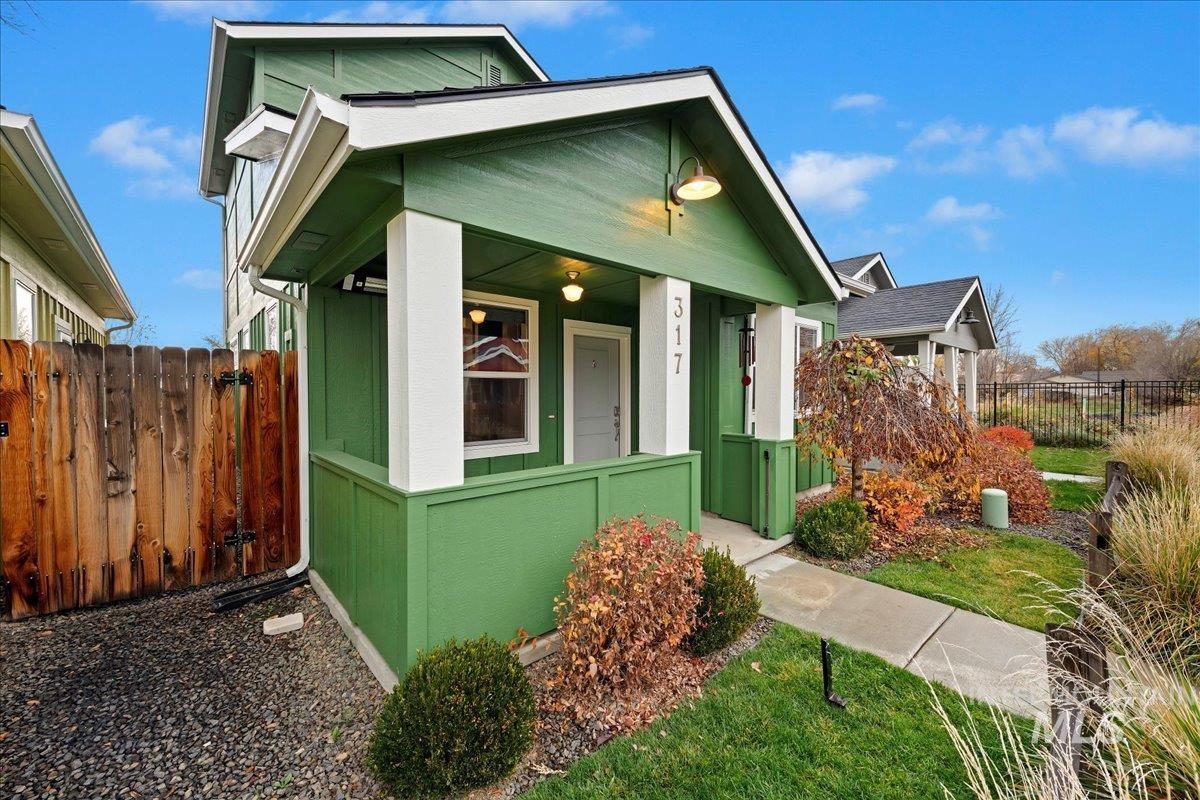 View of side of property featuring covered porch
