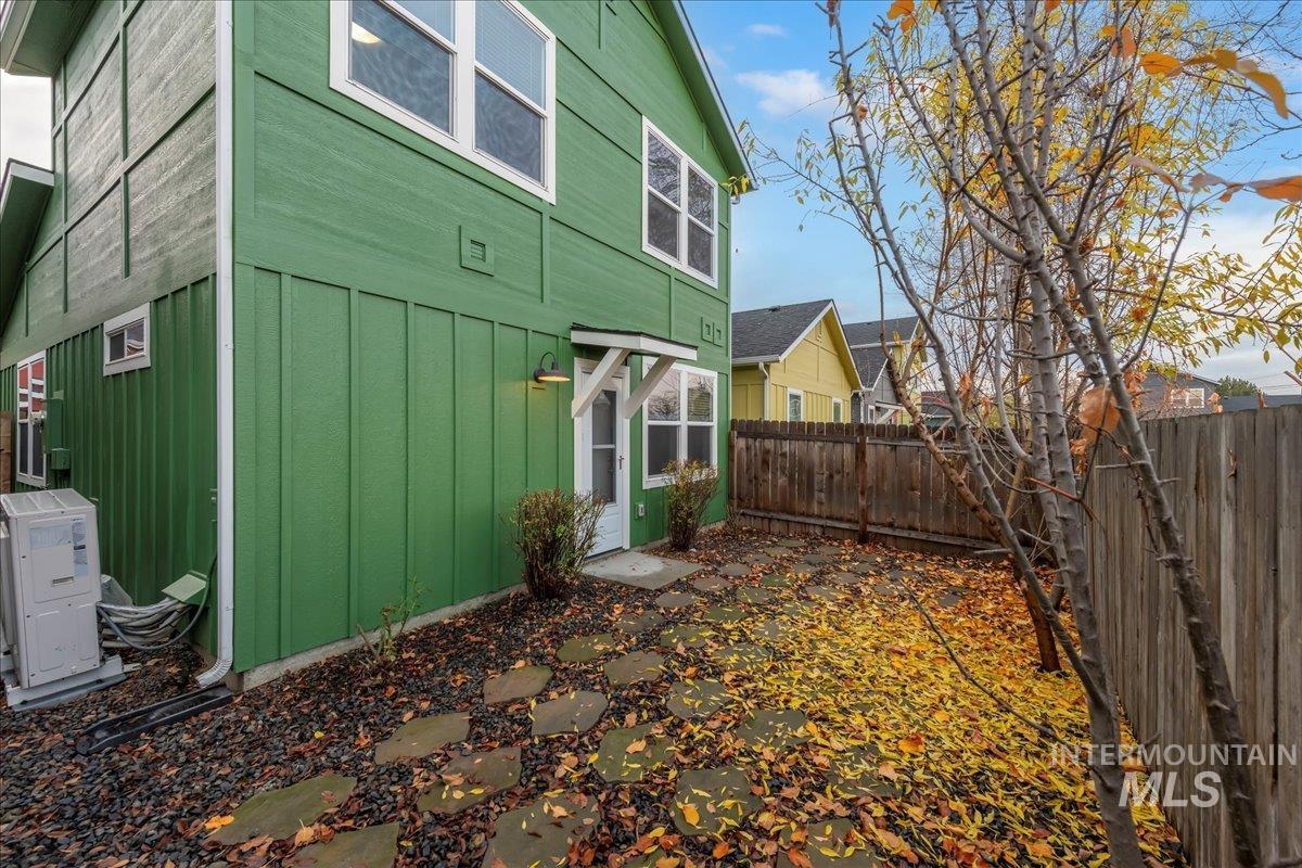 View of home's exterior featuring board and batten siding and a fenced backyard