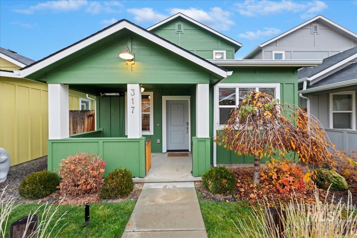 View of front of home with a porch and board and batten siding
