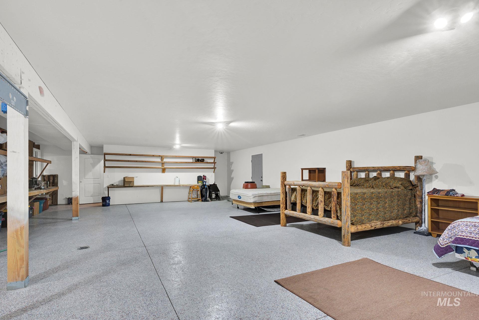 Oversized Recreation Room with sealed concrete flooring and additional storage areas