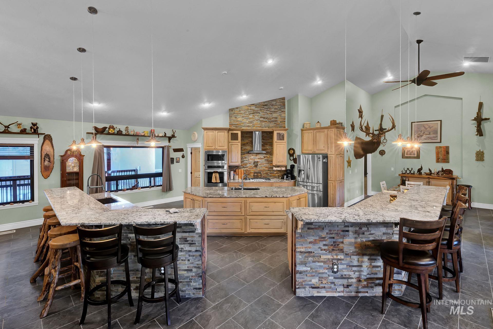 Double stone front breakfast bars with granite counters and plentiful cooking area