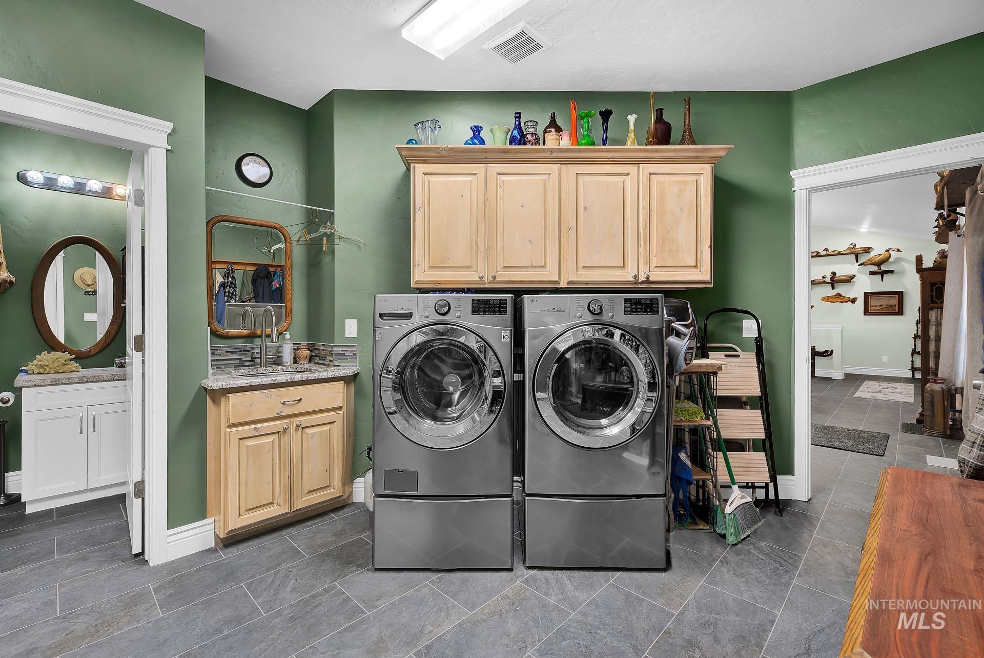 Laundry Room with extra built in cabinetry and a half bath attached