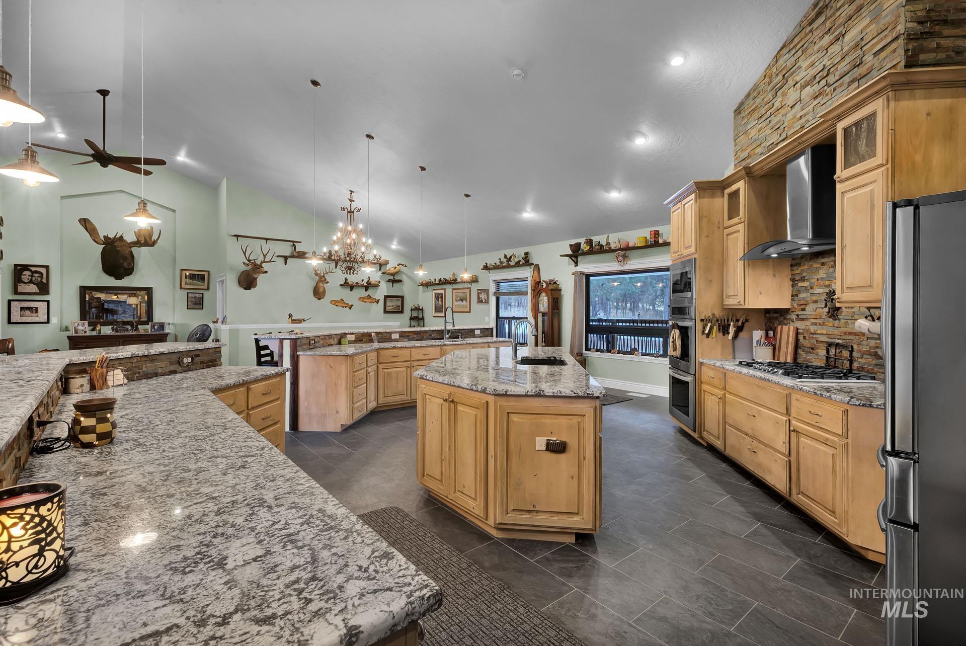 Center Island amidst plentiful cabinetry and stainless appliances