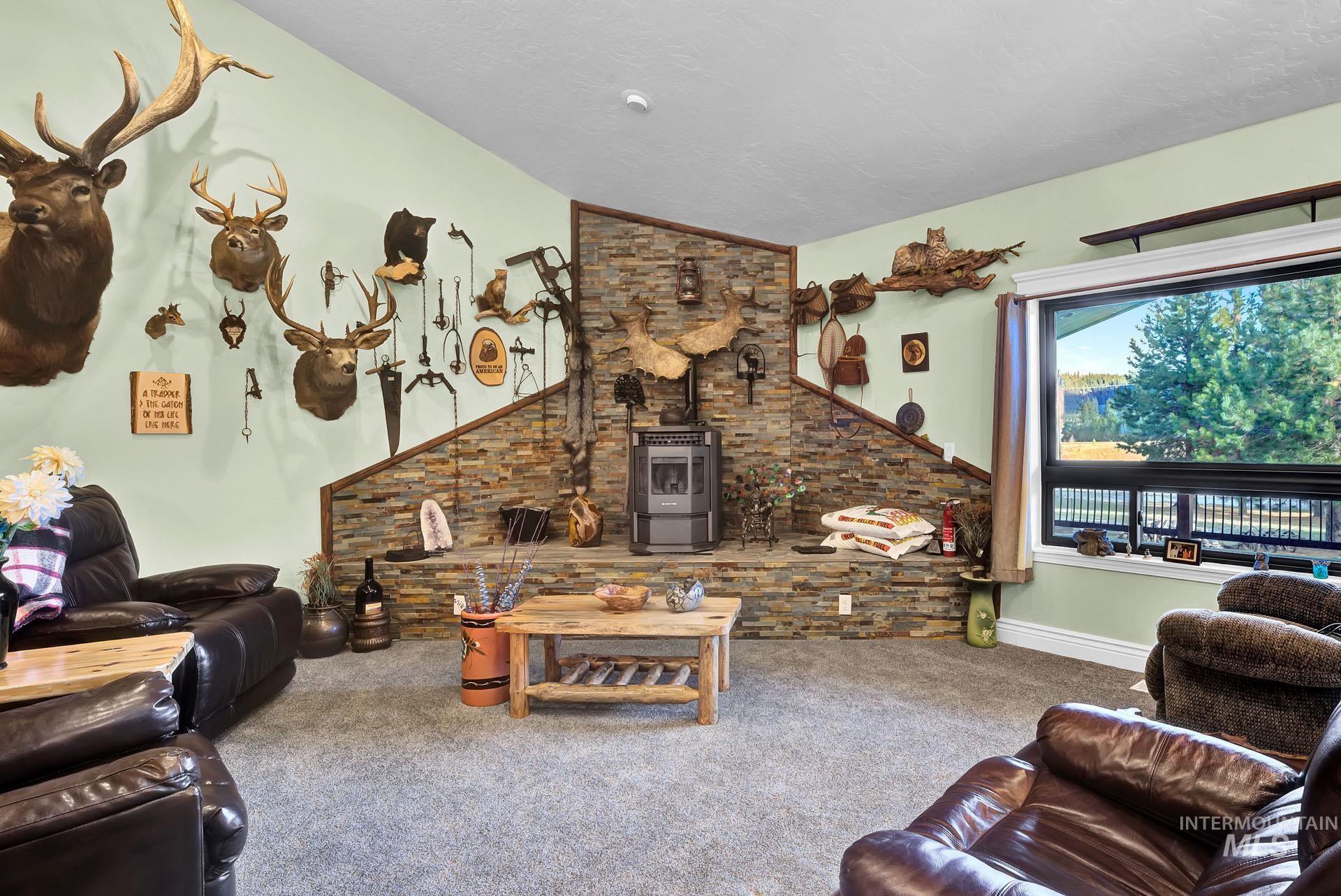 Family Room with Oakley Stone Corner Back drop - raised stone hearth and Pellet Stove