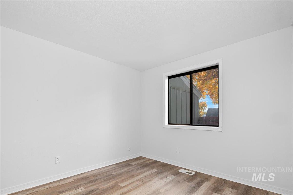 Empty room featuring light wood-style flooring and baseboards