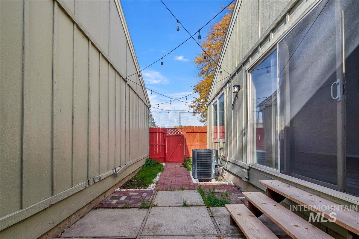 View of patio with a gate and entry steps