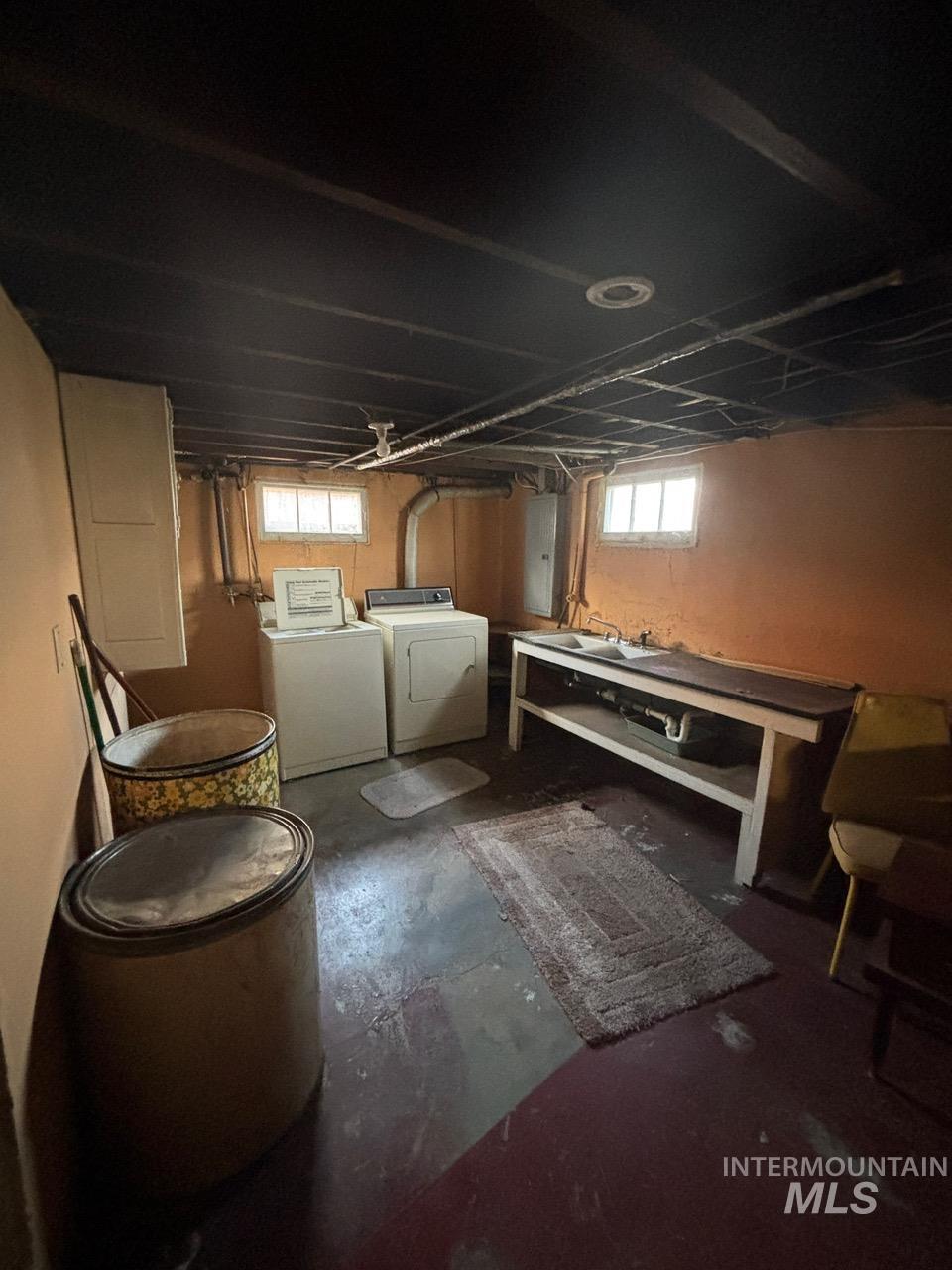 Basement with washer and dryer and electric panel