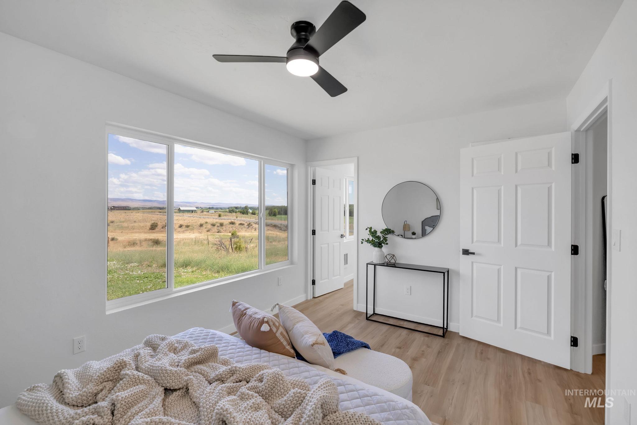 Bedroom featuring light wood-style floors and ceiling fan