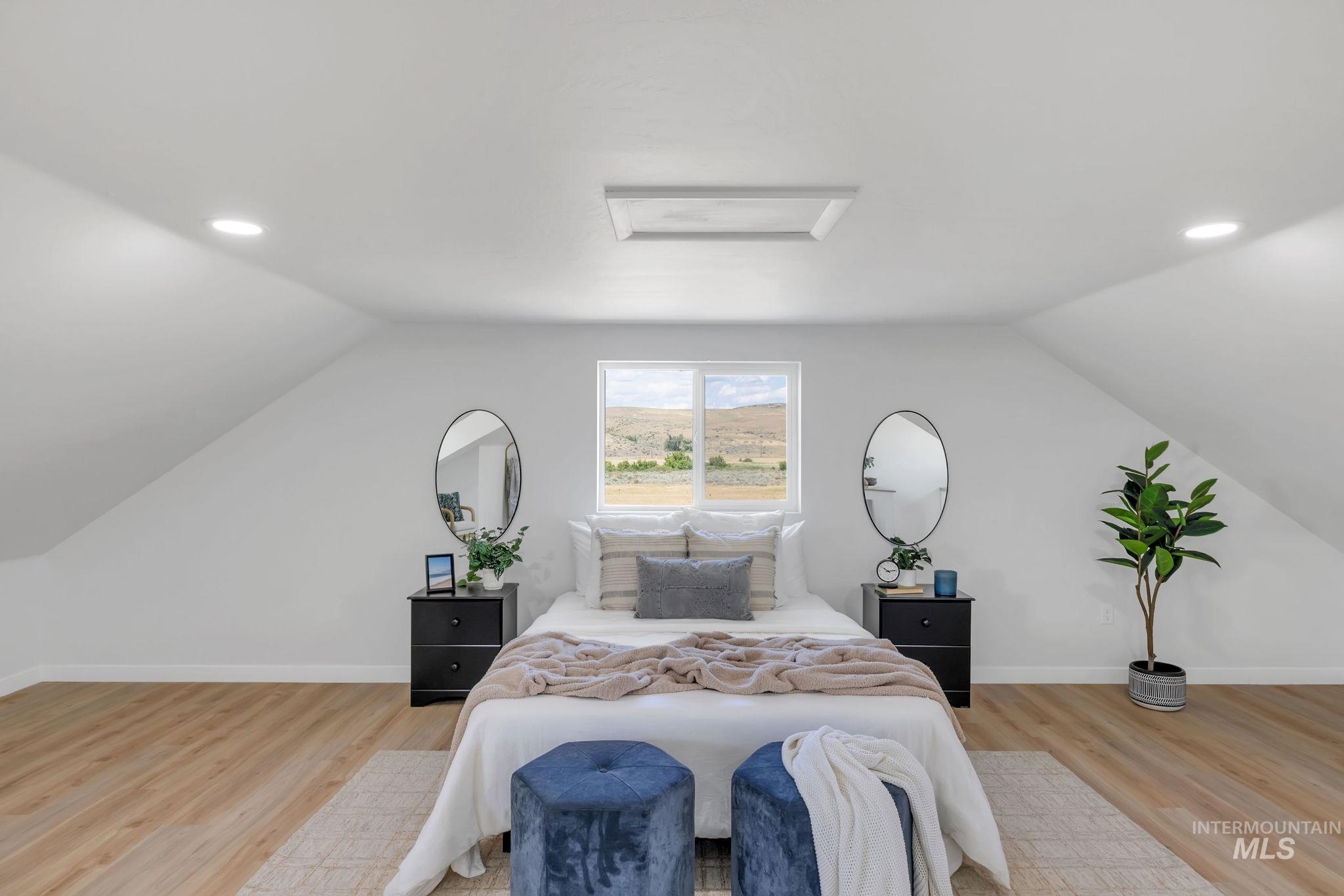 Bedroom with recessed lighting, lofted ceiling, attic access, and light wood-type flooring