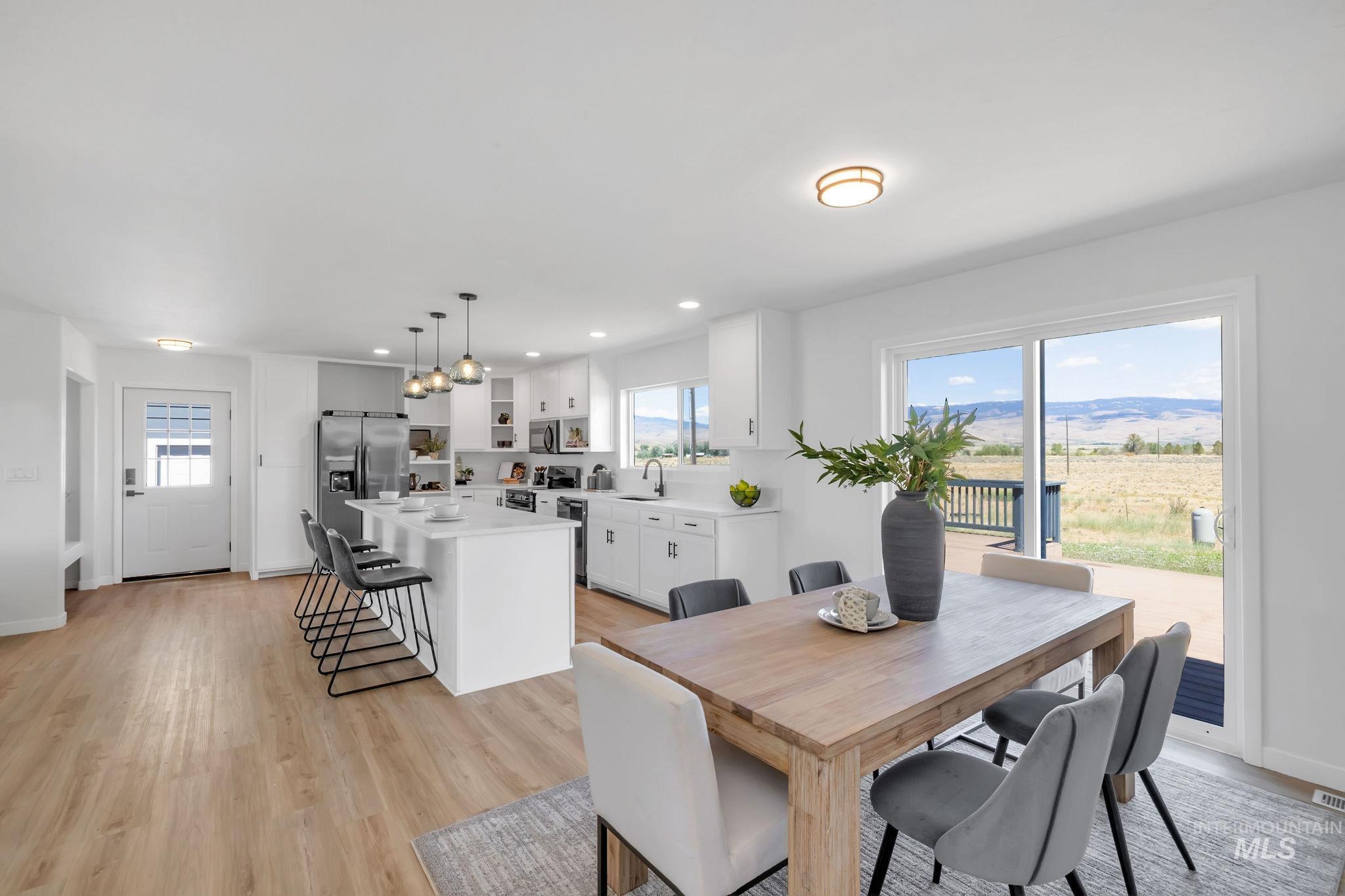 Dining area with light wood finished floors and recessed lighting