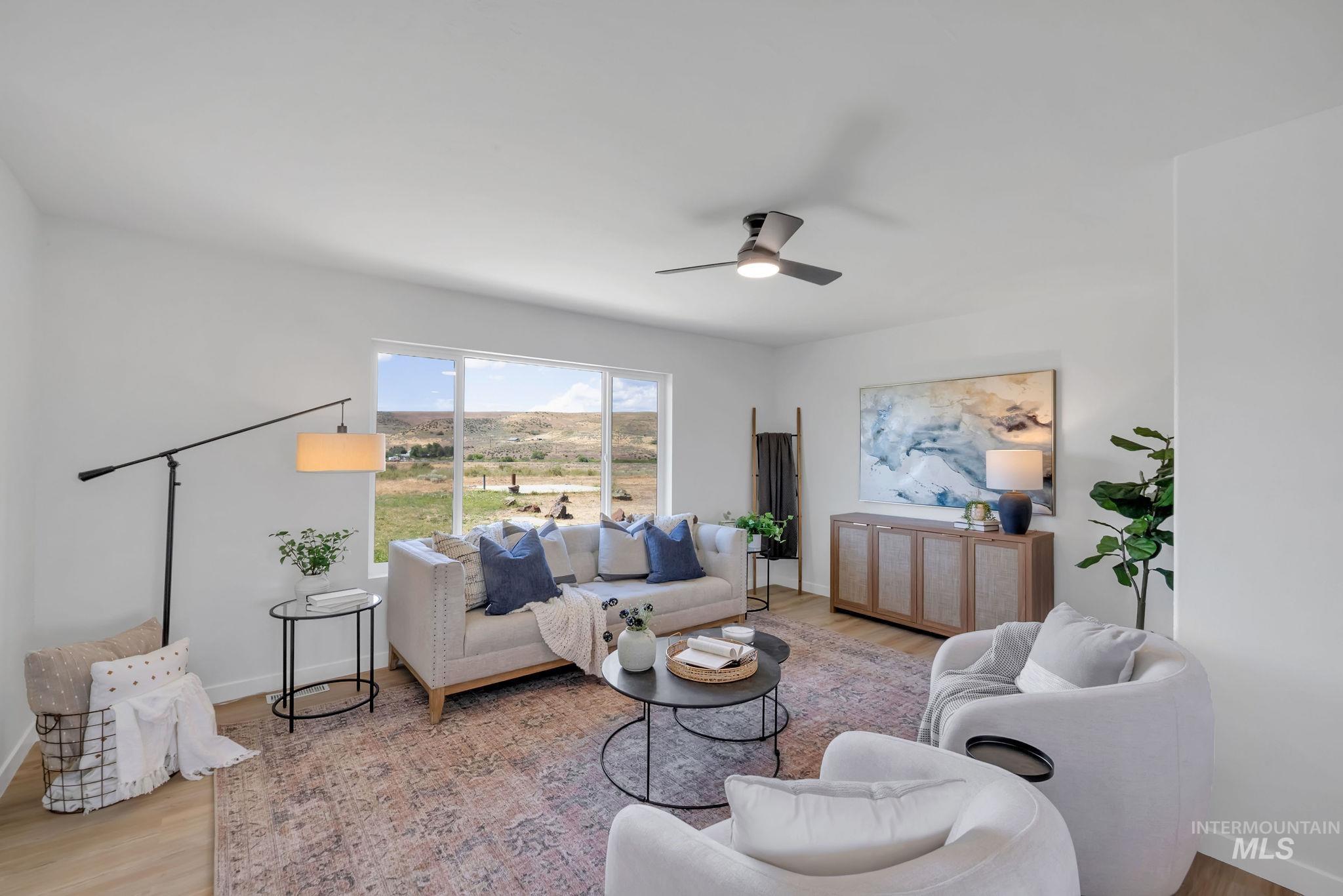 Living room with wood finished floors and a ceiling fan