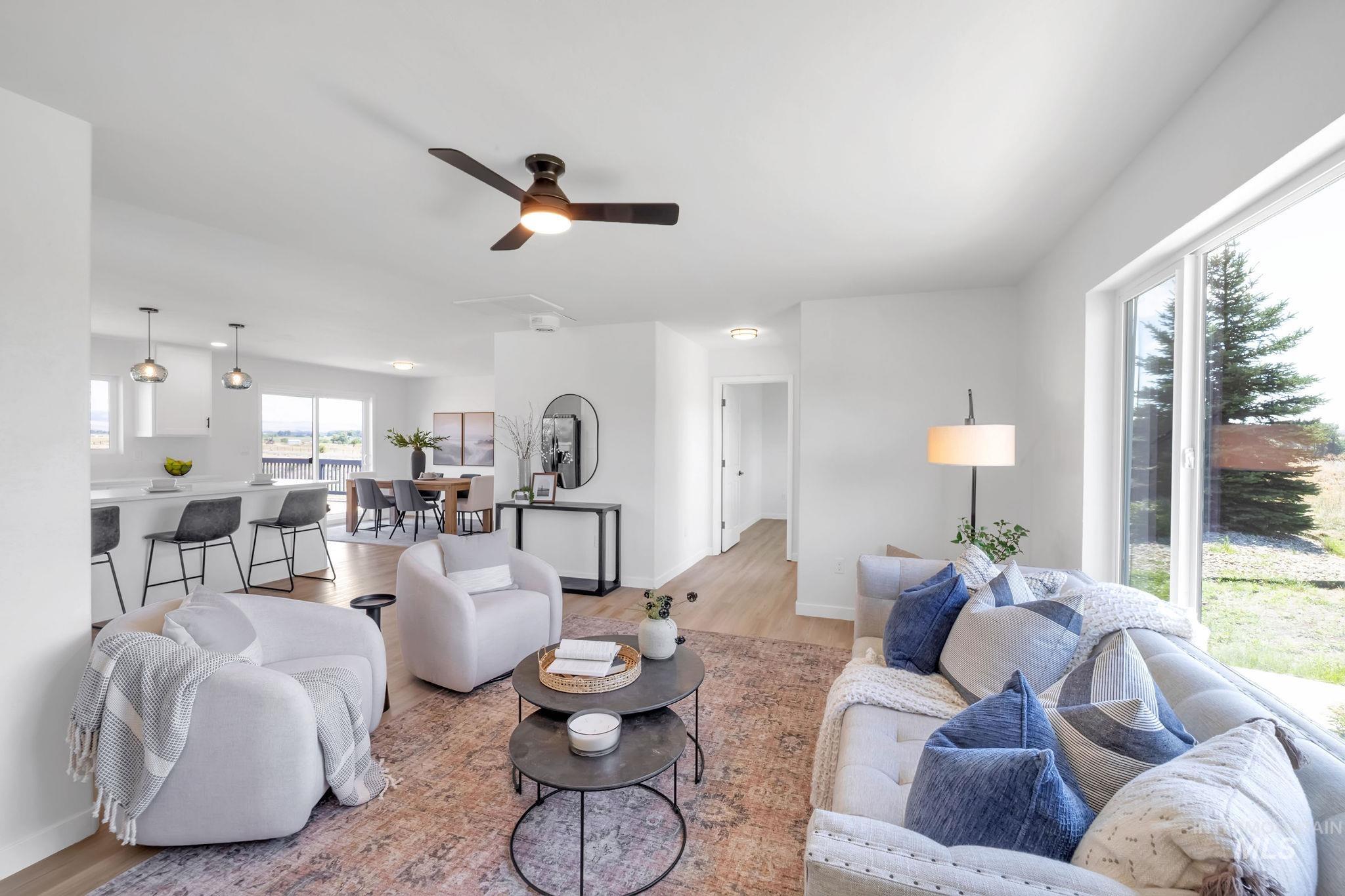 Living room with wood finished floors and ceiling fan