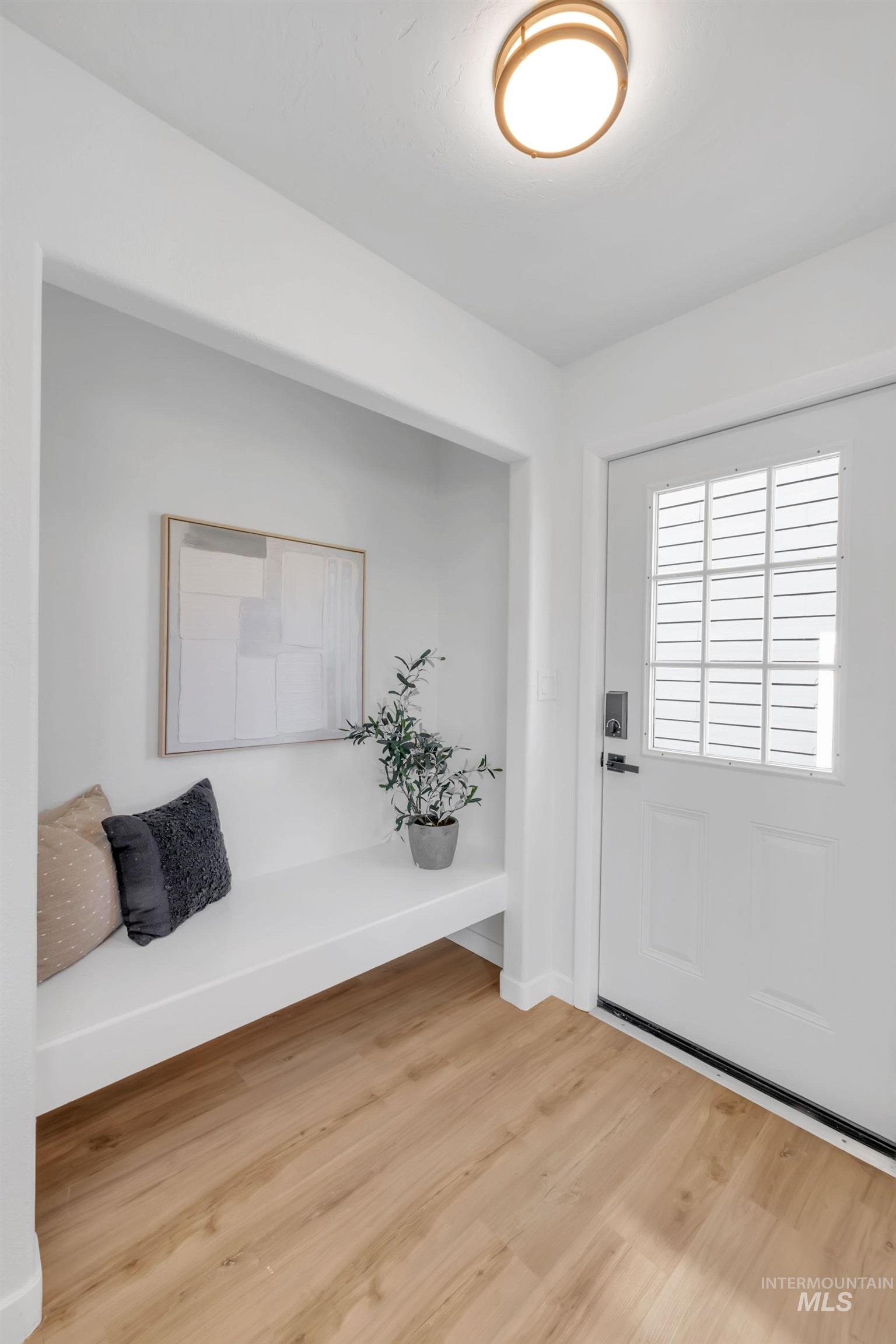 Foyer with wood finished floors and baseboards