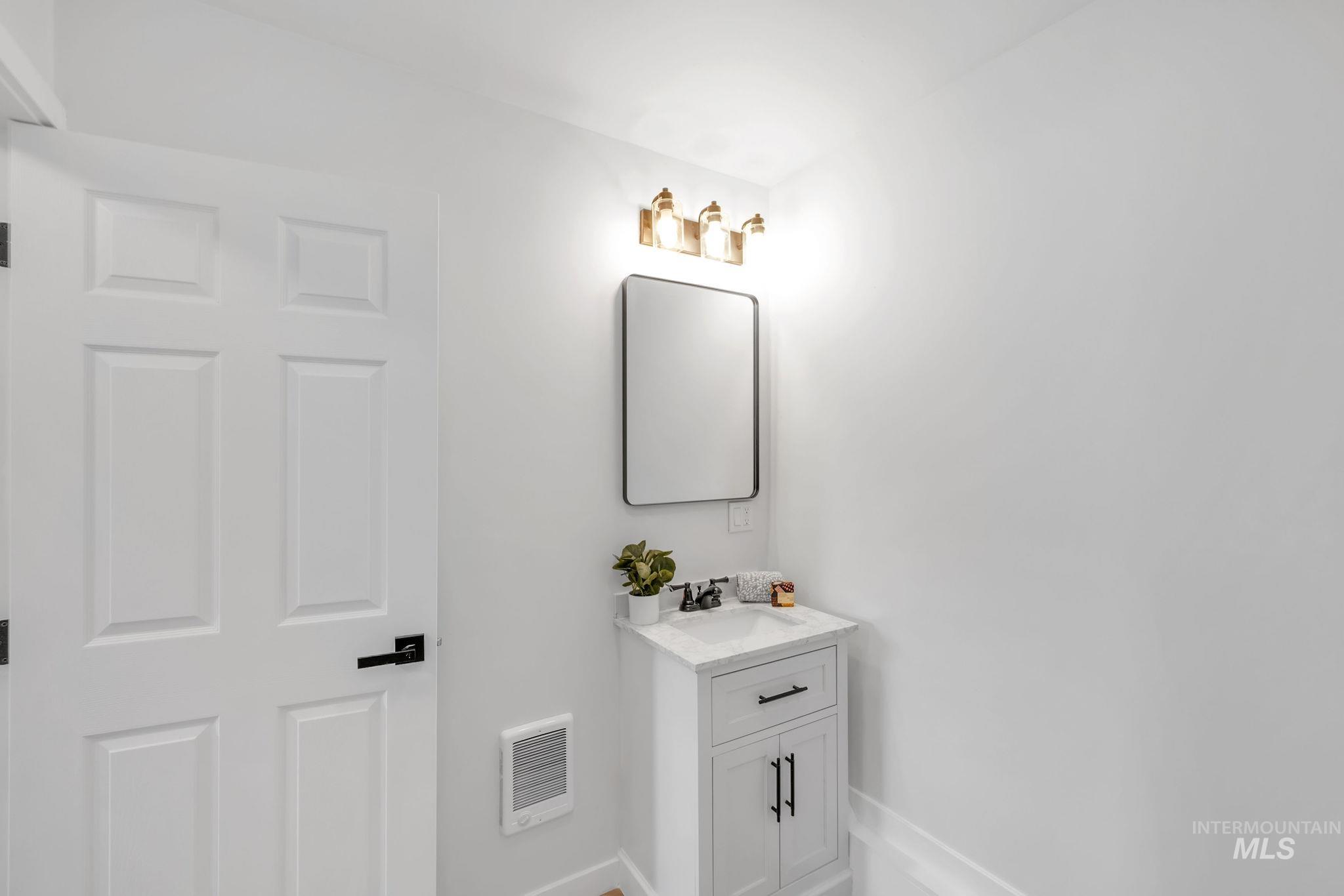 Bathroom with vanity and baseboards
